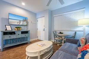 a living room with a couch and a table at Harbour House at the Inn 315 in Fort Myers Beach