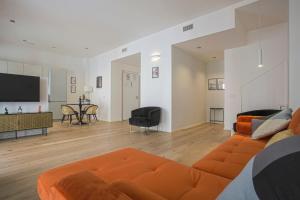 a living room with an orange couch and a table at MILAN CHIC Luxury Apartments-hosted by Sweetstay in Milan