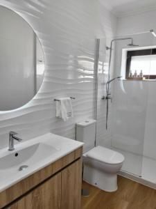 a bathroom with a toilet and a sink and a shower at SonhosQrodopiam Praia da Barra in Praia da Barra +29 photos