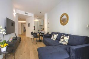 a living room with a blue couch and a table at MILAN CHIC Luxury Apartments-hosted by Sweetstay in Milan