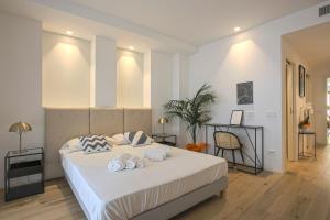 a bedroom with a large white bed with shoes on it at MILAN CHIC Luxury Apartments-hosted by Sweetstay in Milan