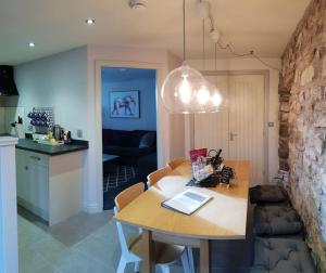 a kitchen and living room with a table and a dining room at Hawks Barn in Horton in Ribblesdale