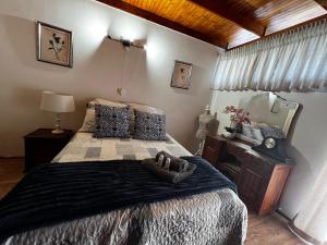 a bedroom with a large bed and a mirror at Six Second Avenue in Parys