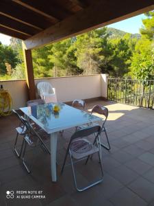 a white table and chairs on a patio at La Costeta de Beseit in Beceite