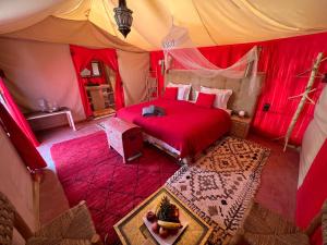 a bedroom with a bed in a tent at Luxury traditional Tent Camp in Merzouga