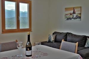 a living room with a bottle of wine on a table at Rebhof Kaltern in Caldaro