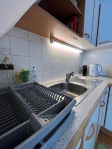 a kitchen with a sink and a counter top at Cosy apartment in central location in Vienna