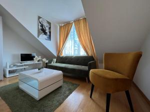 sala de estar con sofá y silla en Cosy apartment in central location, en Viena