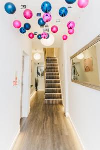 a room with a staircase with balloons on the ceiling at Prime Suites Lytham in Lytham St Annes