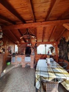 ein Esszimmer mit einem Tisch und einem Kamin in der Unterkunft Casa Rustica in Borşa