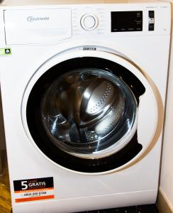 a white washing machine with its door open at Apartment White der Sportschule Badura in Leipzig