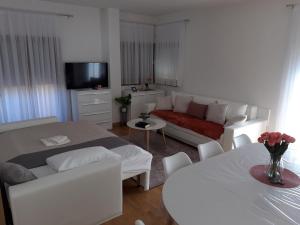 a living room with a bed and a couch at Marys Home Apartment Međugorje in Međugorje