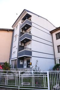 a building with balconies on the side of it at Demir Apartmani in Novi Pazar