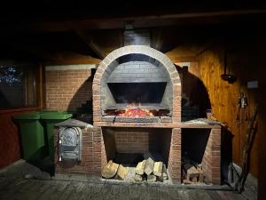 a brick oven with a fire inside of it at Vila Eduard in Fundata