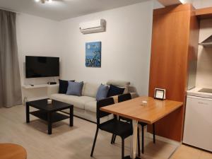 a living room with a couch and a table at Ευ ζην Central / Ev zen central in Nicosia