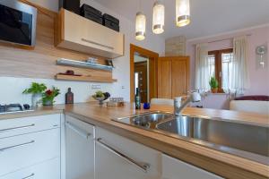 a kitchen with a stainless steel sink and wooden counters at Magic holiday Apartment in Bale
