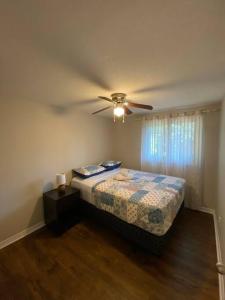 a bedroom with a ceiling fan and a bed at AleHar House in Kingston