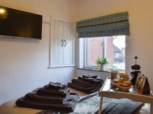 a room with a bunch of towels on a table at Gavels Gap in Nantwich