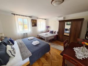 a bedroom with a bed and a living room at Beatrix Suites in Budva