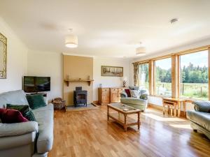 a living room with a couch and chairs and a table at Benmore Drimfern - Uk38742 in Benmore