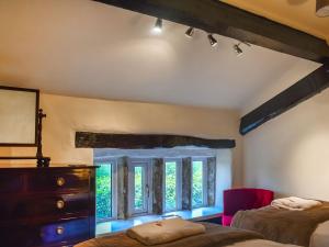 a bedroom with two beds and a window at Foxstones Farm House in Worsthorne