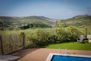 a swimming pool with a view of a mountain at Moinho do Avô in Torres Vedras