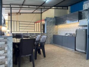 a kitchen with chairs and a table in a kitchen at Homely condo in Lonavala in Lonavala