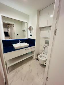 a bathroom with a sink and a toilet at Batumi Rest Apartament in Batumi