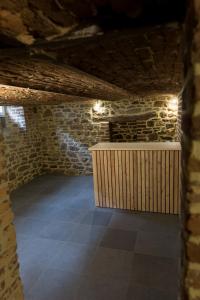 a dark room with a stone wall and a counter at Gite Kooa Prestige in Theux