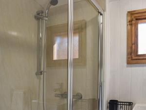 a shower with a glass door in a bathroom at Keldholme Shepherds Hut in Kirkbymoorside