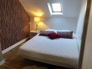 a bedroom with a bed with two pillows and a window at SEA-YOU Etaples-Le Touquet in Étaples