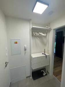 a white bathroom with a sink and a mirror at Luxury apartment Trio Harrachov A.2 in Harrachov