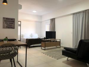 uma sala de estar com uma cama e um sofá em Apartamento Wi-fi, Split, Estacionamento e Piscina em Ribeirão Preto