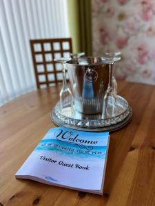 a welcome sign sitting on top of a wooden table at Seaside 2 bedroom house with large garden in Rhyl