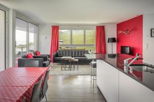 a kitchen and living room with red walls at Bella Vista in Fieschertal