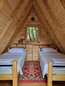 a bedroom with two beds in a attic at Wolf & Sheep Nature & Adventure in Podgorica