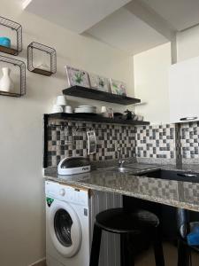 a kitchen with a washing machine and a sink at nice little apartment with swimming pool in Agadir