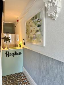 a reception counter in a room with a picture on the wall at Aragon House in Peterborough