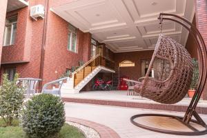 a swing in the courtyard of a house at AHMAD HOTEL in Samarkand
