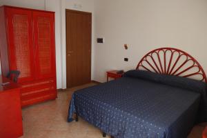 a bedroom with a blue bed and a red cabinet at Beach Hotel in Diamante +53 photos