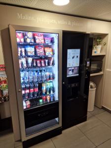 a soda refrigerator in a store with drinks in it at B&B HOTEL Corbeil-Essonnes in Corbeil-Essonnes