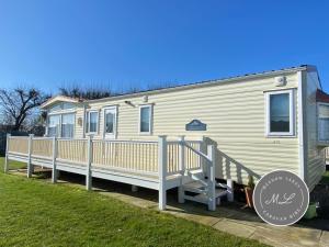 a mobile home with a porch and a deck at Golden Palm - Sherwood 472 - S472 in Skegness