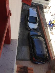 two cars parked in a parking lot next to a building at Casa Vacanze in Santa Maria di Castellabate