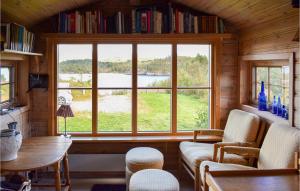 a room with a large window and a table and chairs at Gorgeous Home In Aksdal With Kitchen in Aksdal