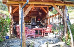 a wooden cabin with chairs and a table in it at Gorgeous Home In Aksdal With Kitchen in Aksdal +16 photos
