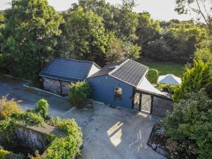 an overhead view of a blue house with solar panels on it at The Rose Suite Kenmare in Kenmare