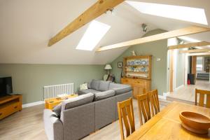 a living room with a couch and a table at Luxury three bedroom property with hot tub in West Wellow