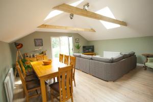 a living room with a couch and a table at Luxury three bedroom property with hot tub in West Wellow