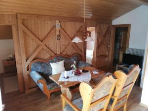 a dining room with a table and a couch at Ferienwohnung Emilia mit Bergblick (Osten) in Ruhpolding