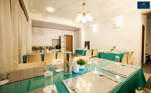 a dining room with green tables and chairs at Divine's The Elite Zong in Lachung